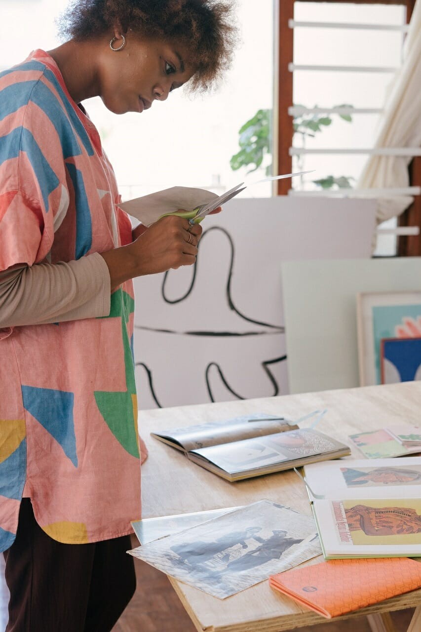 women designer making paper cutouts