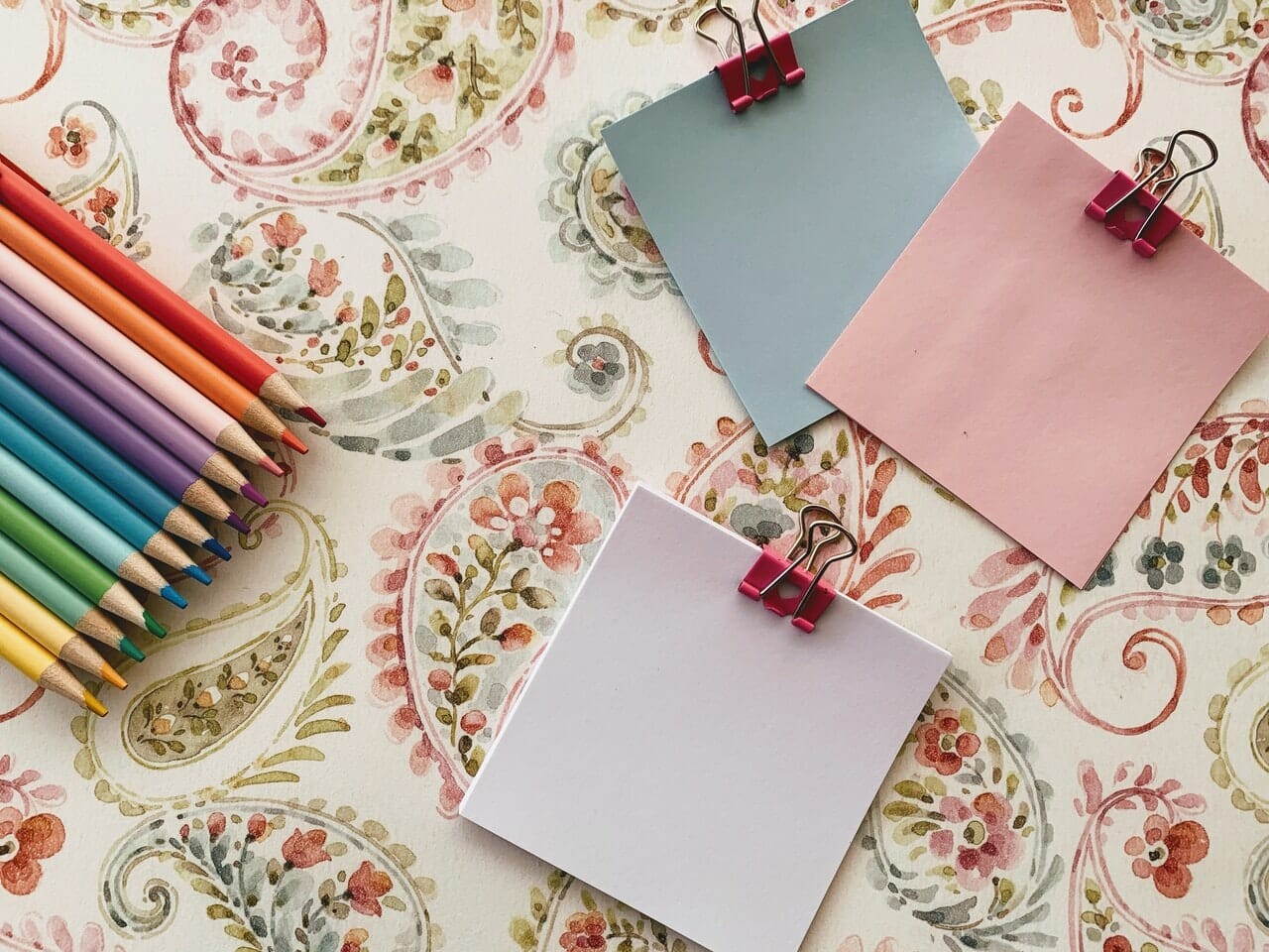 pink papers with colored pencils