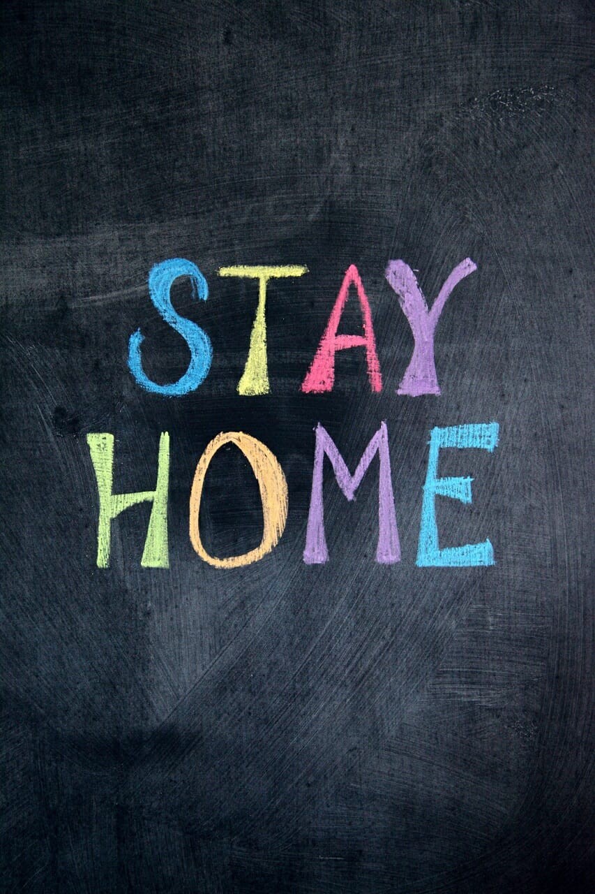 multicolored stay home written on chalkboard