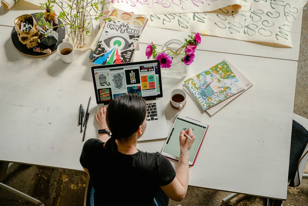 women writing on tablet