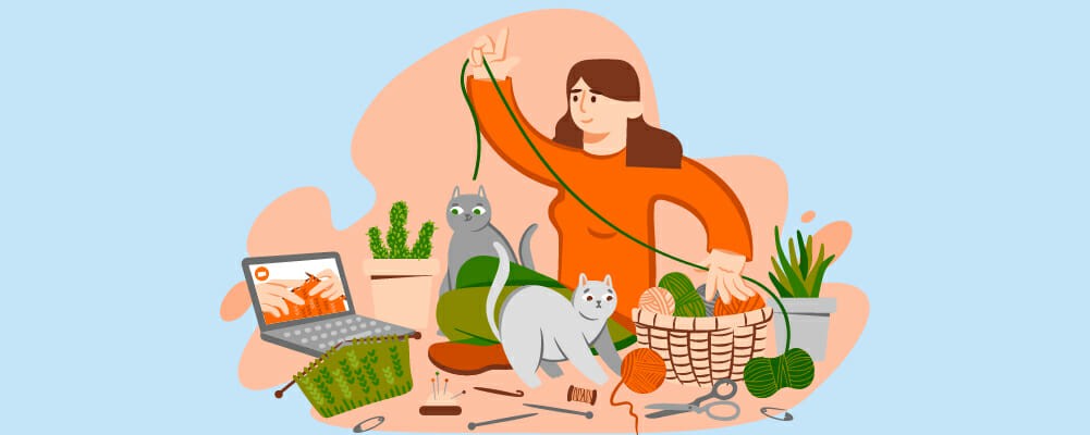 woman with yarns with two cats