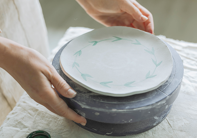 painting a clay bowl