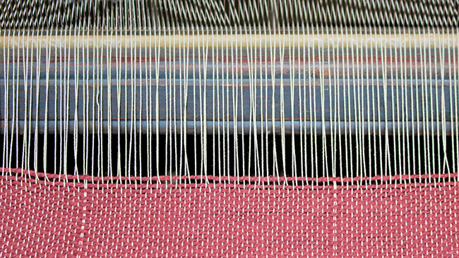 What are warp and weft in textile weaving