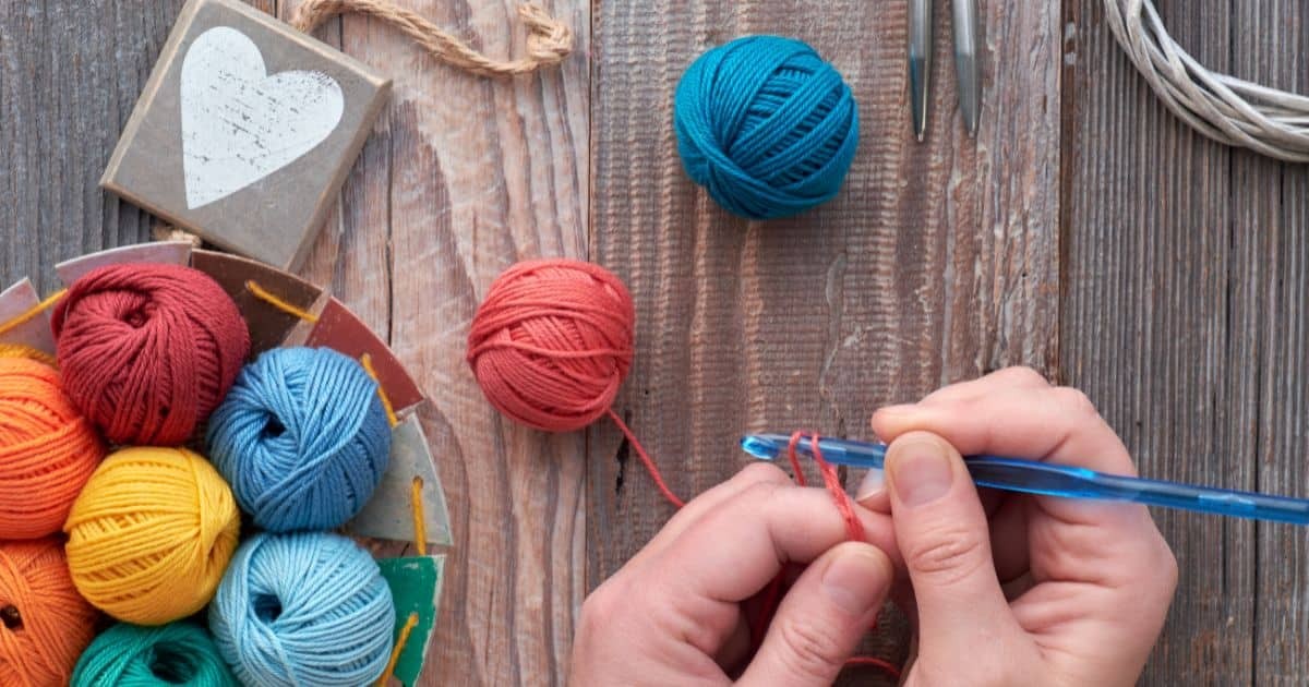 Hands with Crochet Hook and Yarn Balls