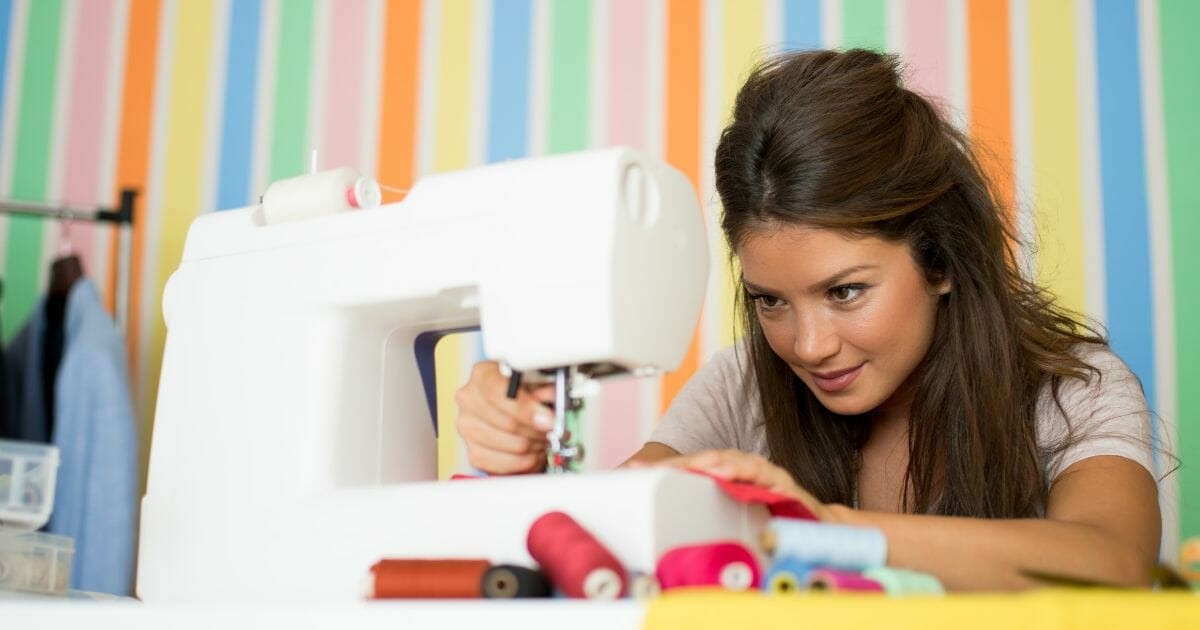 fashion designer sewing with sewing machine